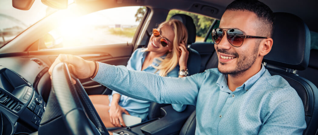 a couple in a new automobile