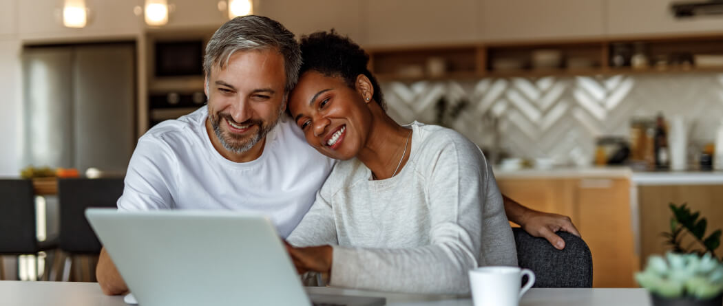 a couple looking at their laptop