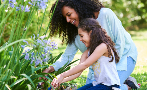 Mom and child planting flowers